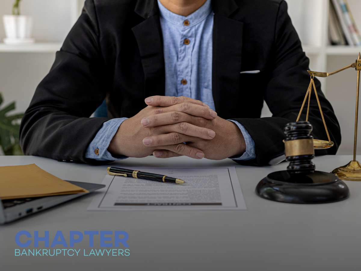 Bankruptcy lawyer discusses Bankruptcy Exemptions at desk with legal scales and gavel