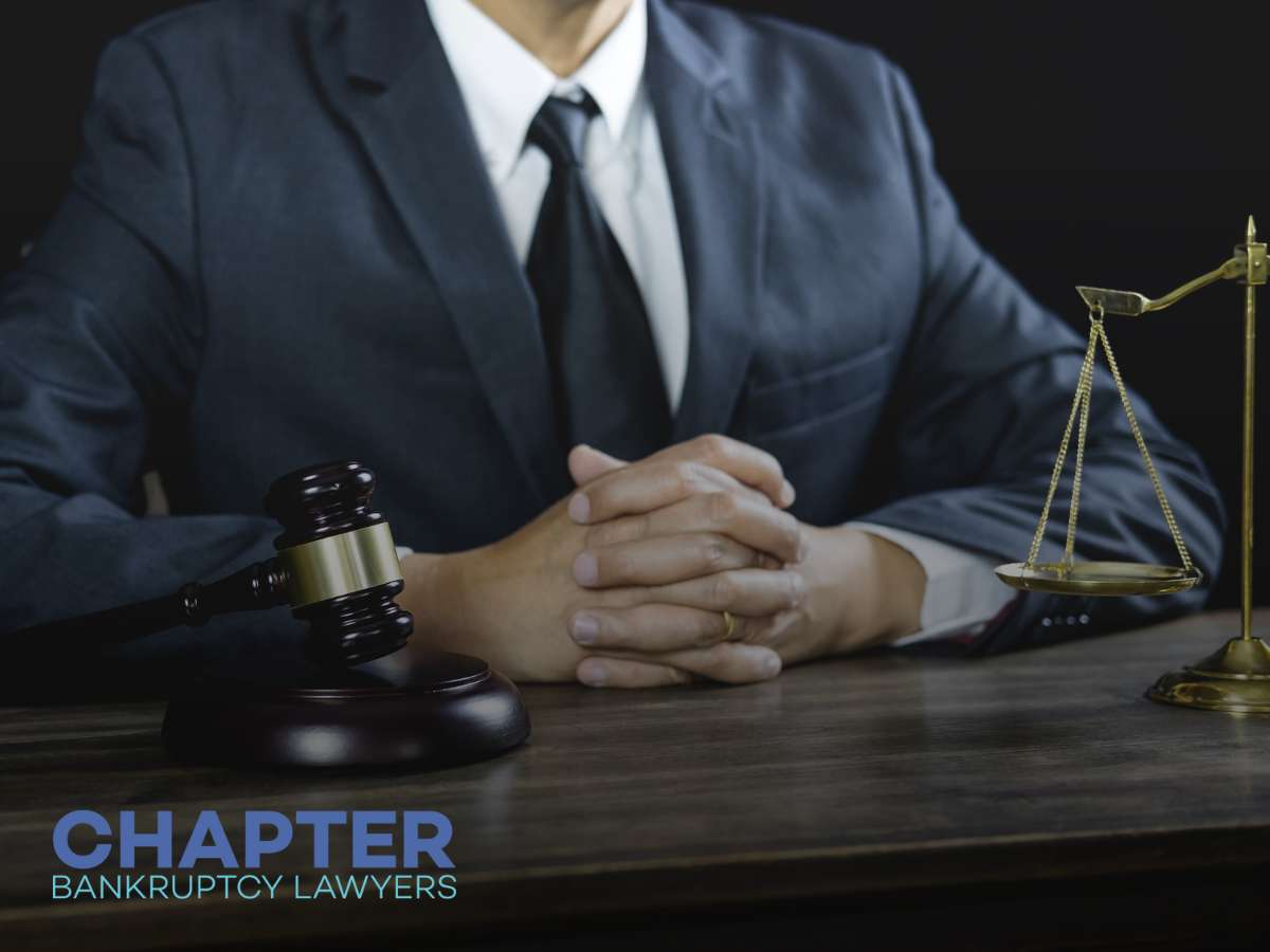 Bankruptcy lawyer discussing case with gavel and scales of justice
