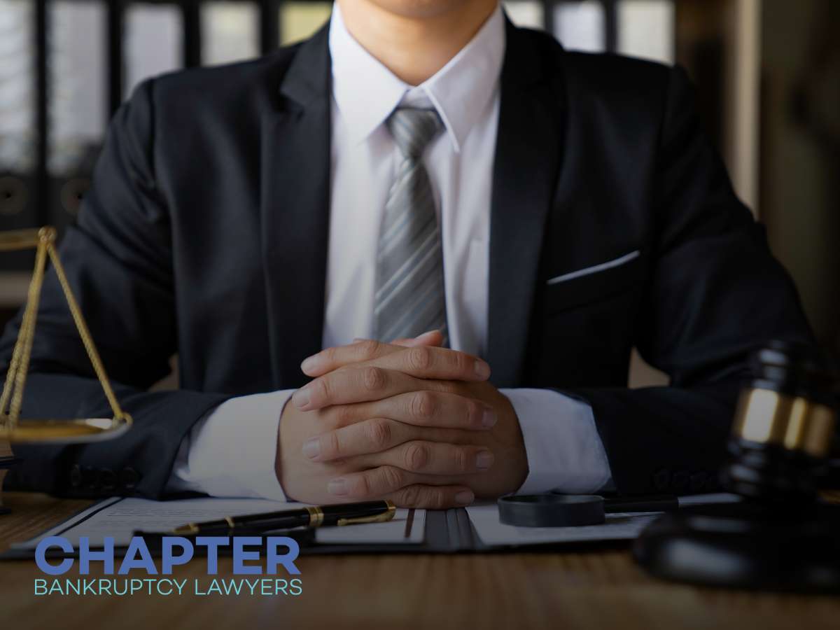 A lawyer in a suit sitting at a desk, prepared for a discussion about filing for bankruptcy.